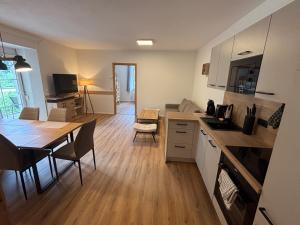 a kitchen with a table and a dining room at Anita Apartments in Flattach