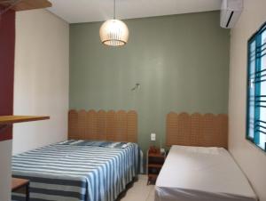a bedroom with two beds and a lamp at Solar da Colina in Petrolina +31 photos