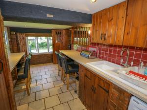 a kitchen with wooden cabinets and a counter top at Severn Bank Lodge in Shrawley