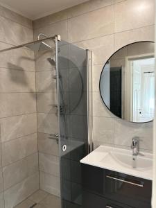 a bathroom with a shower and a sink and a mirror at Nurmeveski Holiday House in Nurme