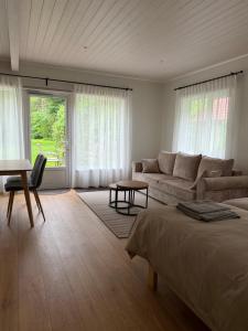 a bedroom with a bed and a couch and a table at Nurmeveski Holiday House in Nurme