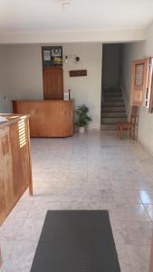 a large room with a staircase and a floor with a rug at Hotel Amaro in Luis Correia
