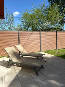 a chair sitting on a patio next to a fence at Nurmeveski Holiday House in Nurme