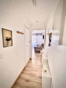 a room with a hallway with a couch and a table at BoHémian Studio in Sète Center in Sète