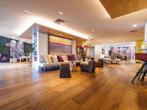 a living room with a couch and chairs at Mercure Valence in Valence