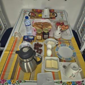 a table with breakfast foods and a tea pot on it at dar Beya in Kairouan