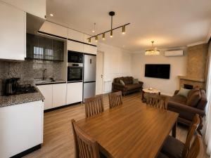 a kitchen and living room with a table and a dining room at phranta in Gonio