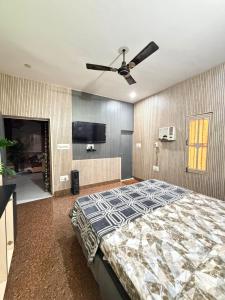 a bedroom with a bed and a ceiling fan at Home stays in Jammu