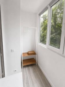 a white room with a shelf and a window at Дом in Almaty