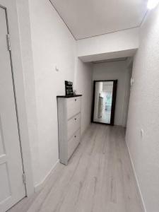 an empty room with a dresser and a mirror at Дом in Almaty