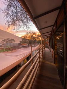 a building with a fence next to a road at kbañita Huacachina in Ica