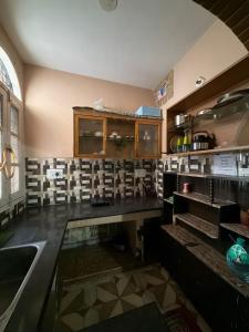 a kitchen with a counter top and a sink at Home stays in Jammu +11 photos