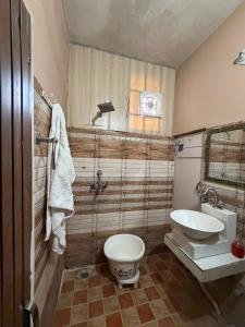 a bathroom with a toilet and a sink at Home stays in Jammu
