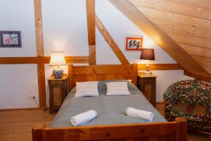 a bedroom with a bed with two pillows on it at Siedlisko Pod Strzechą in Wólka