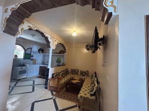 a living room with a fireplace in a house at Sunlight guest house in Taghazout