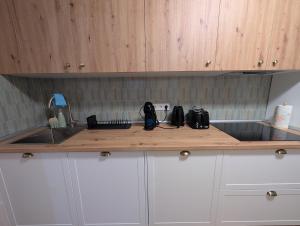 a kitchen with a counter with a sink and a counter top at Mosquera House in Arzúa