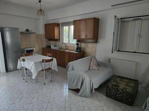 a kitchen with a table and a couch and a table and a kitchen with at Nature & Sea Paradise in Analipsi in Análipsis +17 photos