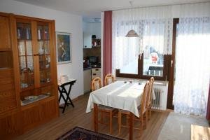 a dining room with a table and chairs and a window at Apartment Rose in Todtmoos