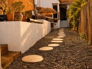 a walkway with stepping stones on the side of a house at Casa do tio Frade in Aldeia do Mato