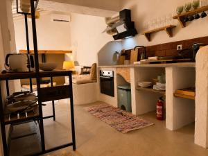 a small kitchen with a counter and a stove at Casa do tio Frade in Aldeia do Mato