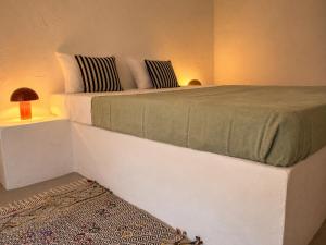 a bedroom with a large white bed in a room at Casa do tio Frade in Aldeia do Mato +15 photos