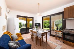 a kitchen and living room with a blue couch and a table at Villa Luna in Simius