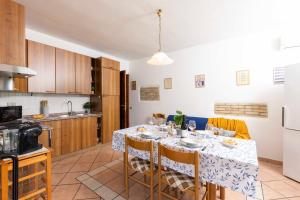 a kitchen with a table with chairs and a kitchen with at Villa Luna in Simius