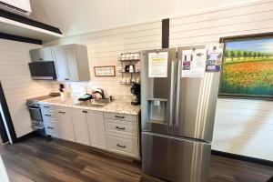 a kitchen with a stainless steel refrigerator and a sink at Red Barn North - 40 in Mead