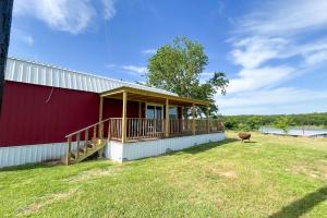 a red building with a deck on the side of it at Red Barn North - 40 in Mead