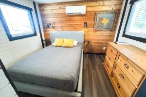 a bedroom with a bed in a tiny house at Red Barn North - 40 in Mead