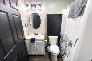 a bathroom with a toilet and a sink and a mirror at Red Barn North - 40 in Mead +36 photos