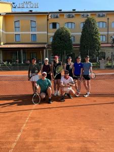 a group of people standing on a tennis court at Ancora Sport Resort Hotel in Meolo