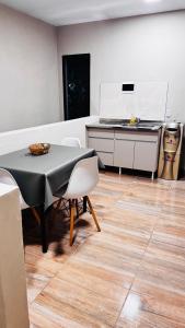 a kitchen with a table and chairs and a counter at SomosRio II Apart in La Cruz