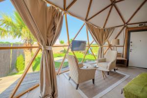 a room with a view in a yurt with chairs and a desk at Belek Glamping House in Çakıllık