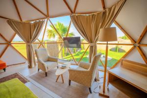 a room with two chairs and a table in a tent at Belek Glamping House in Çakıllık