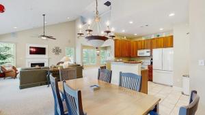 a kitchen and living room with a wooden table and chairs at Bear Trap Dunes - 45D Willow Oak Ave in Ocean View
