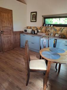 a kitchen with a table and a table and chairs at Pärna Muhu Island 2 in Paenase