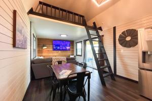 a room with a dining table and a loft bed at Red Barn South - 41 in Mead