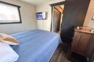 a bedroom with a blue bed and a window at Red Barn South - 41 in Mead