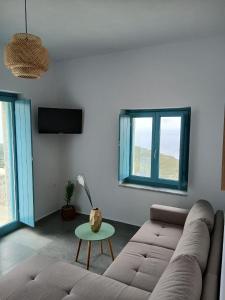 a living room with a couch and a table at Ελαιόλιθοι Μάνη Villas 2 in Oitylo