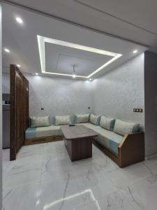 a living room with a couch and a table at Calm and facinating vacation in Saïdia