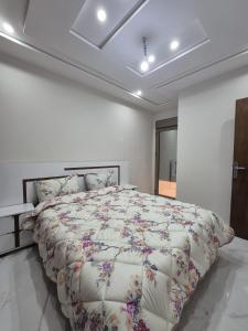 a bedroom with a large bed in a white room at Calm and facinating vacation in Saïdia