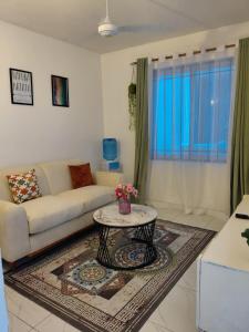 a living room with a couch and a table at Havy Homes in Bamburi