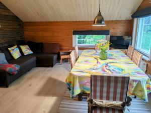 a living room with a table and a couch at Villa Tuomiranta in Porvoo