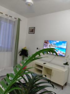 a room with a white desk and a potted plant at Havy Homes in Bamburi