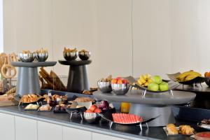 a buffet with different types of food on a table at Althea Resort in Áno Loutrón