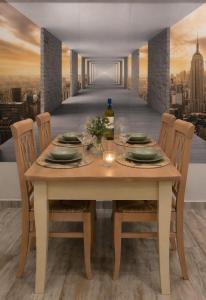 a dining room table with a view of a city at Evergreen Residence VárLak in Debrecen