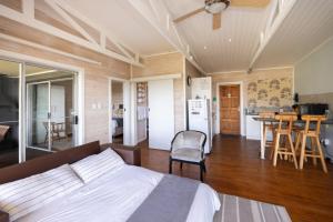 a bedroom with a bed and a kitchen with a table at Big Sky Cottages in Wolseley