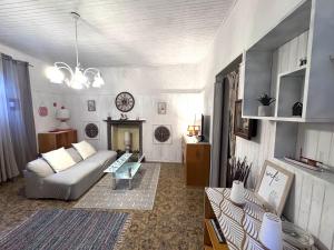 a living room with a couch and a fireplace at Piccolo Borgo vista lago di Como by Gottschalk in Dorio