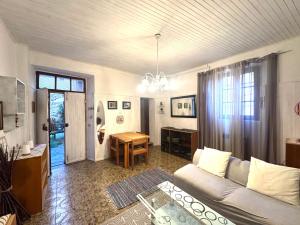a living room with a couch and a table at Piccolo Borgo vista lago di Como by Gottschalk in Dorio